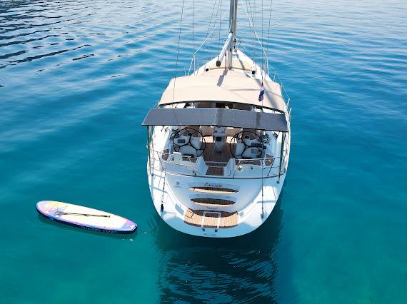 Aerial view of yacht and paddleboard on turquoise water